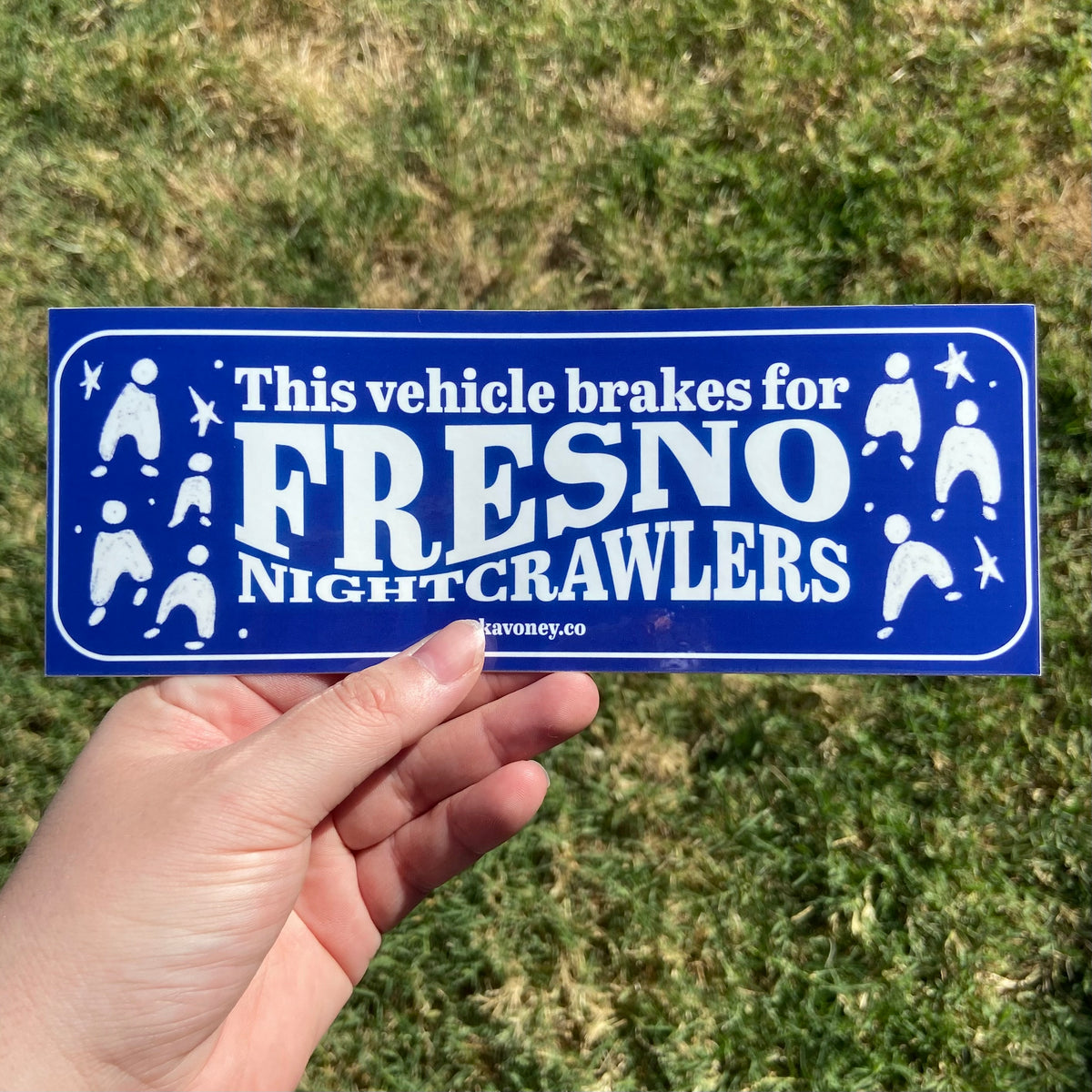 A navy blue rectangular vinyl sticker featuring large text that reads “This Vehicle Brakes for Fresno Nightcrawlers” in white font. At either side of the text are illustrations of some cute Fresno Nightcrawlers.