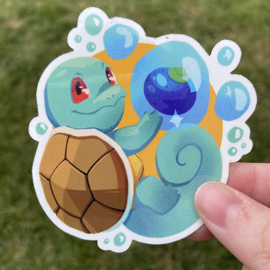 A vinyl sticker of the Pokemon Squirtle and an Oran berry, an in-game item. Squirtle is holding the berry in a floating water bubble alongside it.